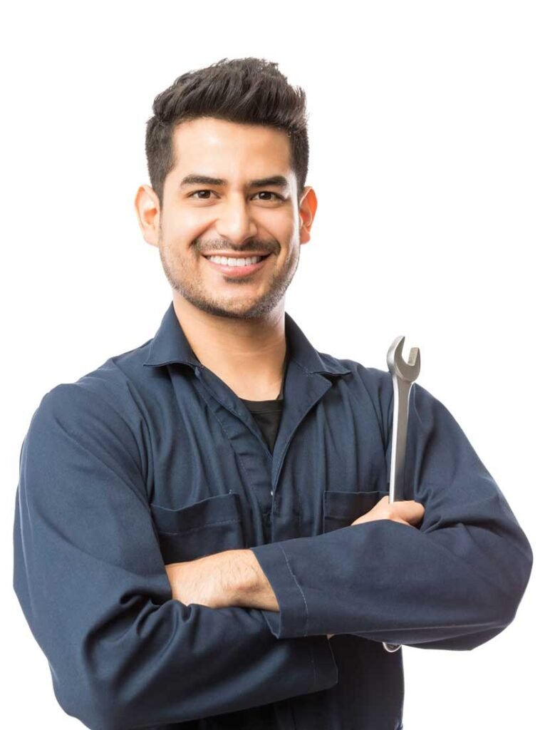 Smiling mechanic in a navy jumpsuit, arms crossed, holding a wrench against a white background.